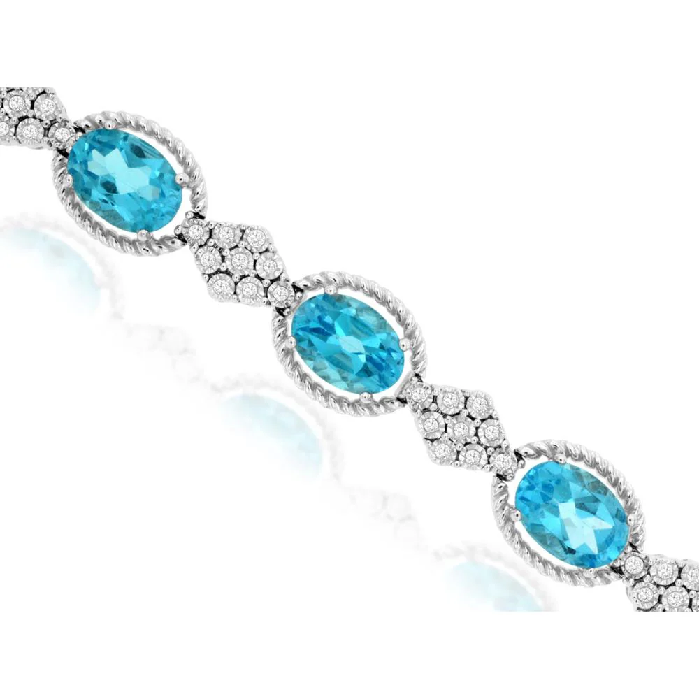 14K White Gold Tennis Bracelet with Oval Blue Topaz and Diamond Cluster Links - 11.20 Carat Blue Topaz, 0.33 Carat Diamond Total Weight - Royal Jewelry