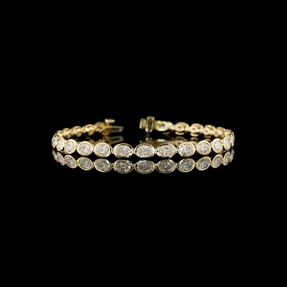 14K Yellow Gold 7.32 Carat Oval Cut Lab Diamond Tennis Bracelet with East-West Bezel Setting - 27 Stones, E-F VS1 Clarity - Covaloro Fine Jewelry