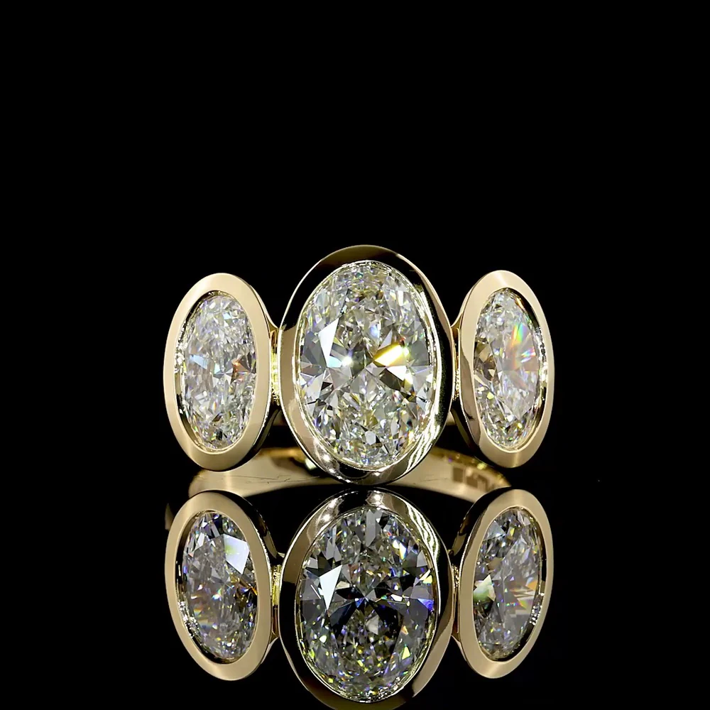 14K Yellow Gold Bezel Set Three Stone Oval Cut Lab Diamond Ring Featuring a 2.01 Carat Center Stone with E-F VVS2 Clarity - 4.07 Carats Total Diamond Weight - Covaloro Fine Jewelry