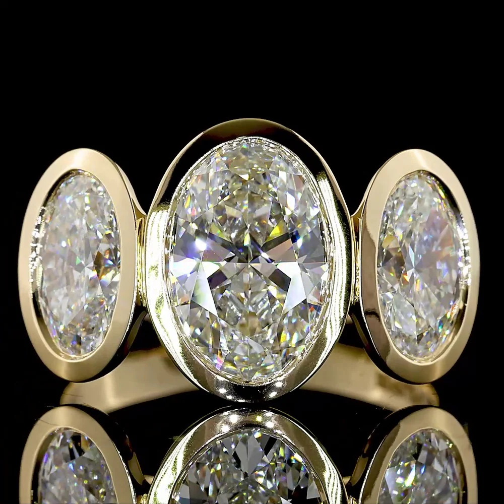 14K Yellow Gold Bezel Set Three Stone Oval Cut Lab Diamond Ring Featuring a 2.01 Carat Center Stone with E-F VVS2 Clarity - 4.07 Carats Total Diamond Weight - Covaloro Fine Jewelry - Image 2