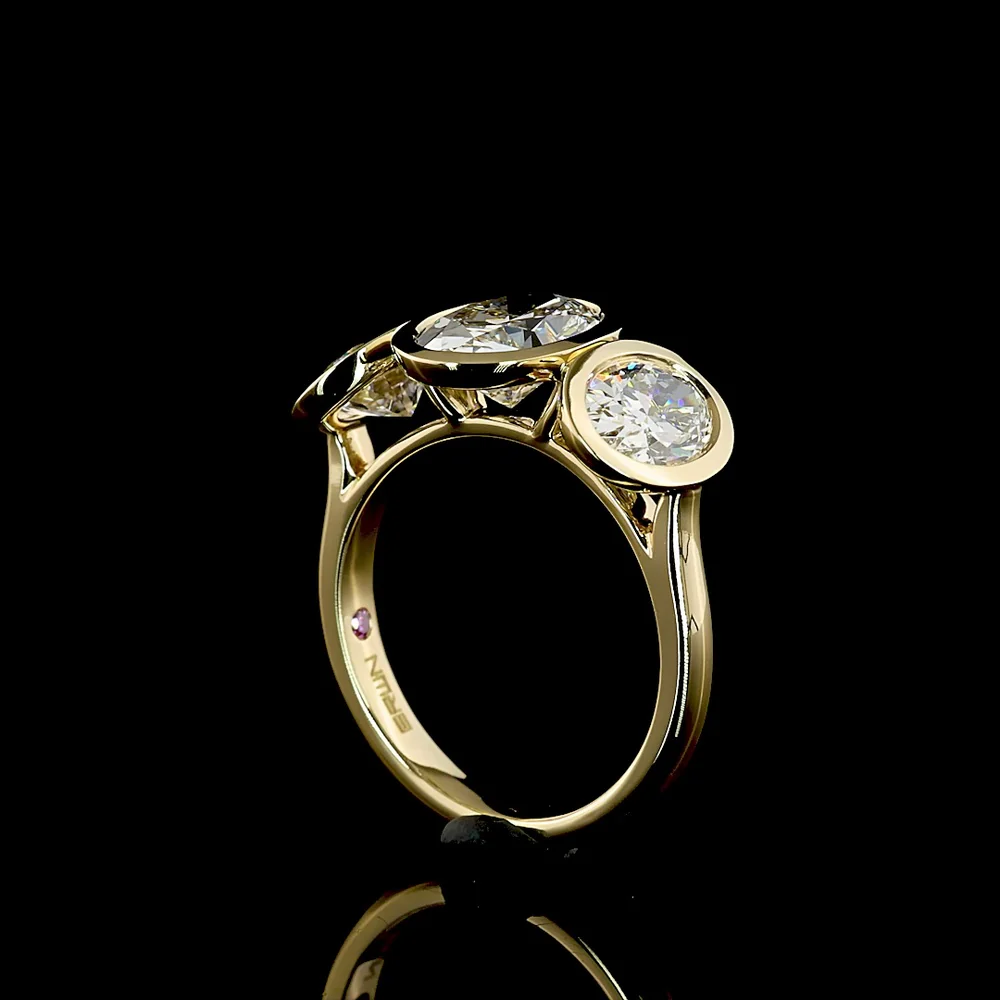 14K Yellow Gold Bezel Set Three Stone Oval Cut Lab Diamond Ring Featuring a 2.01 Carat Center Stone with E-F VVS2 Clarity - 4.07 Carats Total Diamond Weight - Covaloro Fine Jewelry - Image 3