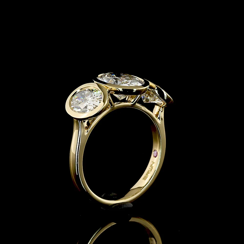 14K Yellow Gold Bezel Set Three Stone Oval Cut Lab Diamond Ring Featuring a 2.01 Carat Center Stone with E-F VVS2 Clarity - 4.07 Carats Total Diamond Weight - Covaloro Fine Jewelry - Image 4