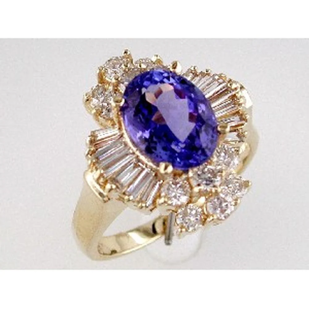 14K Yellow Gold Oval Tanzanite & Diamond Halo Ring with Baguette and Round Accents - 2.50 Carat Total Tanzanite Weight - Royal Jewelry