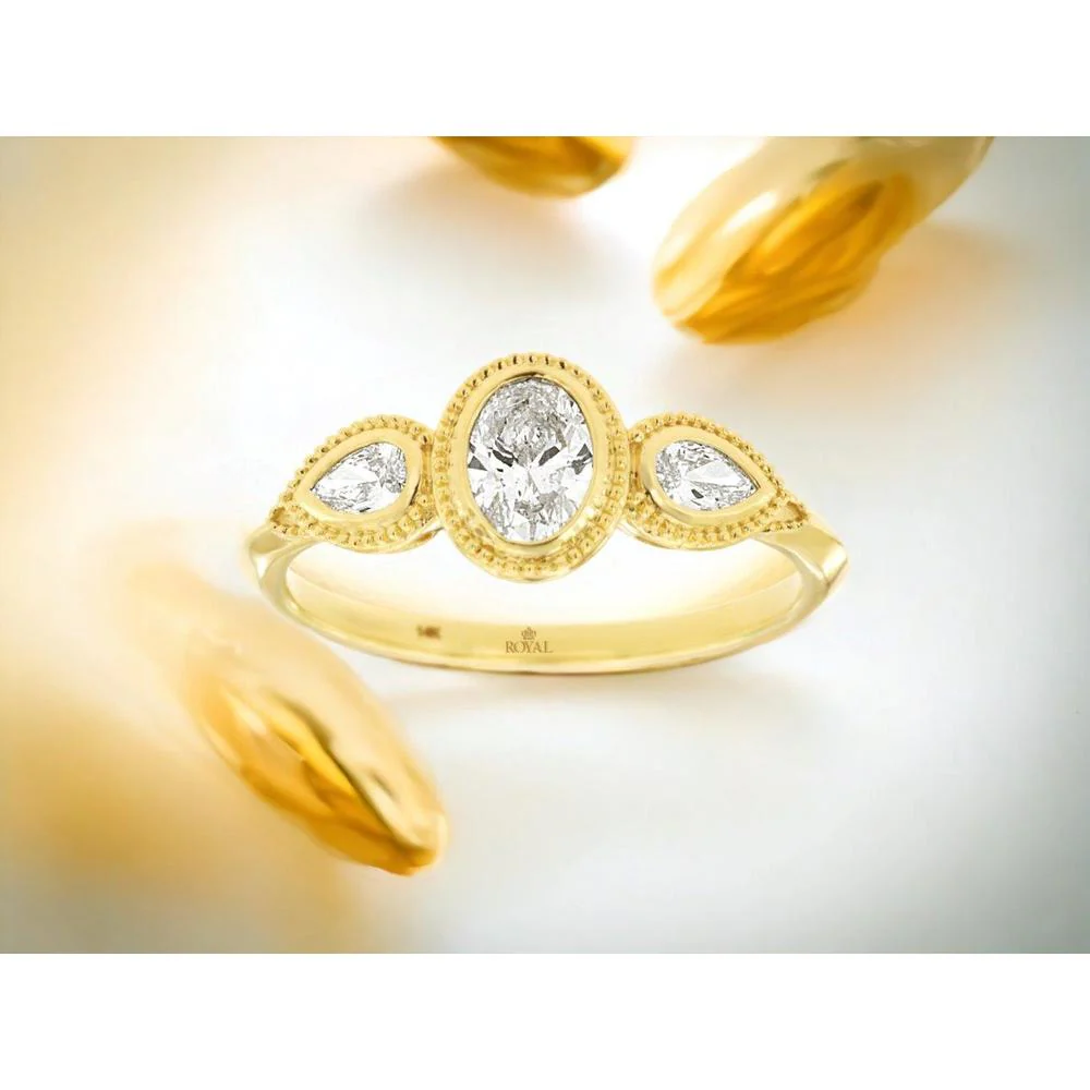 14K Yellow Gold Three Stone Engagement Ring with 0.60 Carat Oval Diamond and Milgrain Detail, Featuring Pear Shaped Side Diamonds - Royal Jewelry - Image 2